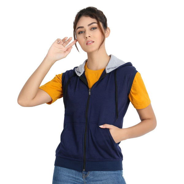 Model wearing Teemoods Women's Fleece Sleeveless Hooded Sweatshirt with zip closed over half sleeves tee and jeans.
